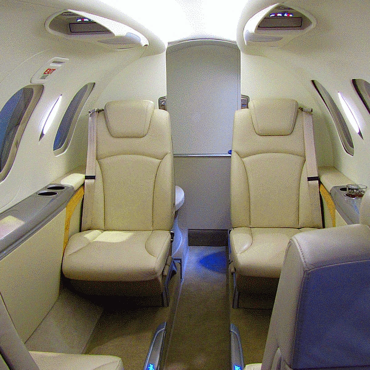 Interior of a private jet cabin with spacious leather seats arranged in a comfortable layout.