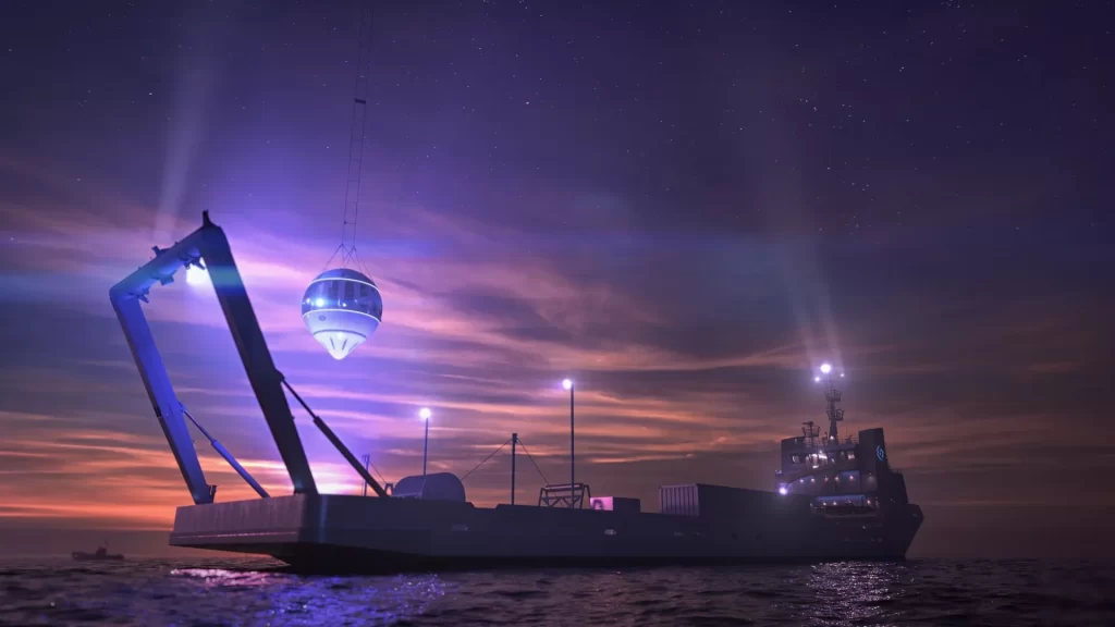 A futuristic space capsule being retrieved onto a ship at dusk, with the sky lit in purple and orange hues and the sea reflecting the ship's lights.