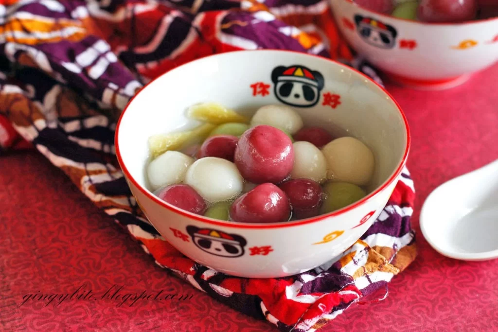 A bowl of colorful Tangyuan, sweet glutinous rice balls, in a warm sweet soup traditionally enjoyed during the Dongzhi Festival