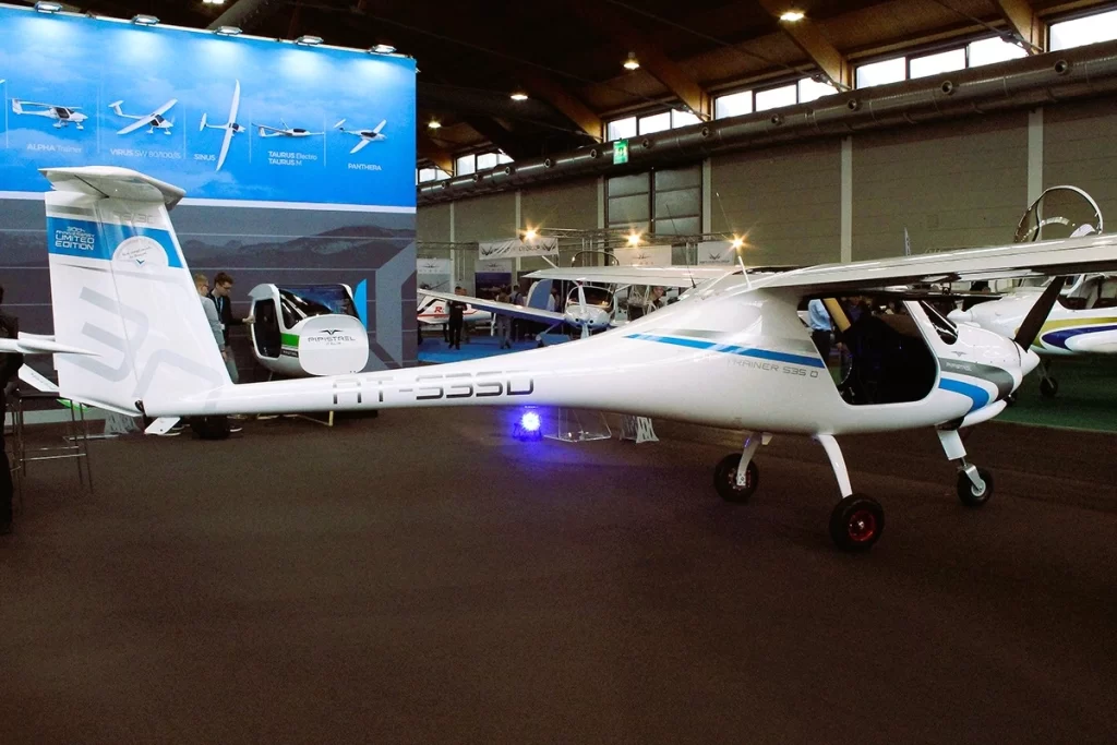 A Pipistrel Alpha Trainer on display at an aviation expo, showcasing its sleek and lightweight design