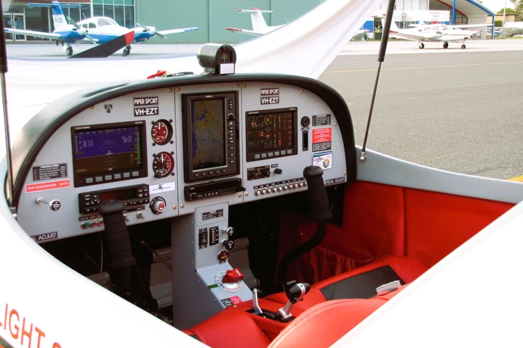 Interior cockpit of a light sport aircraft featuring modern avionics, navigation systems, and ergonomic controls