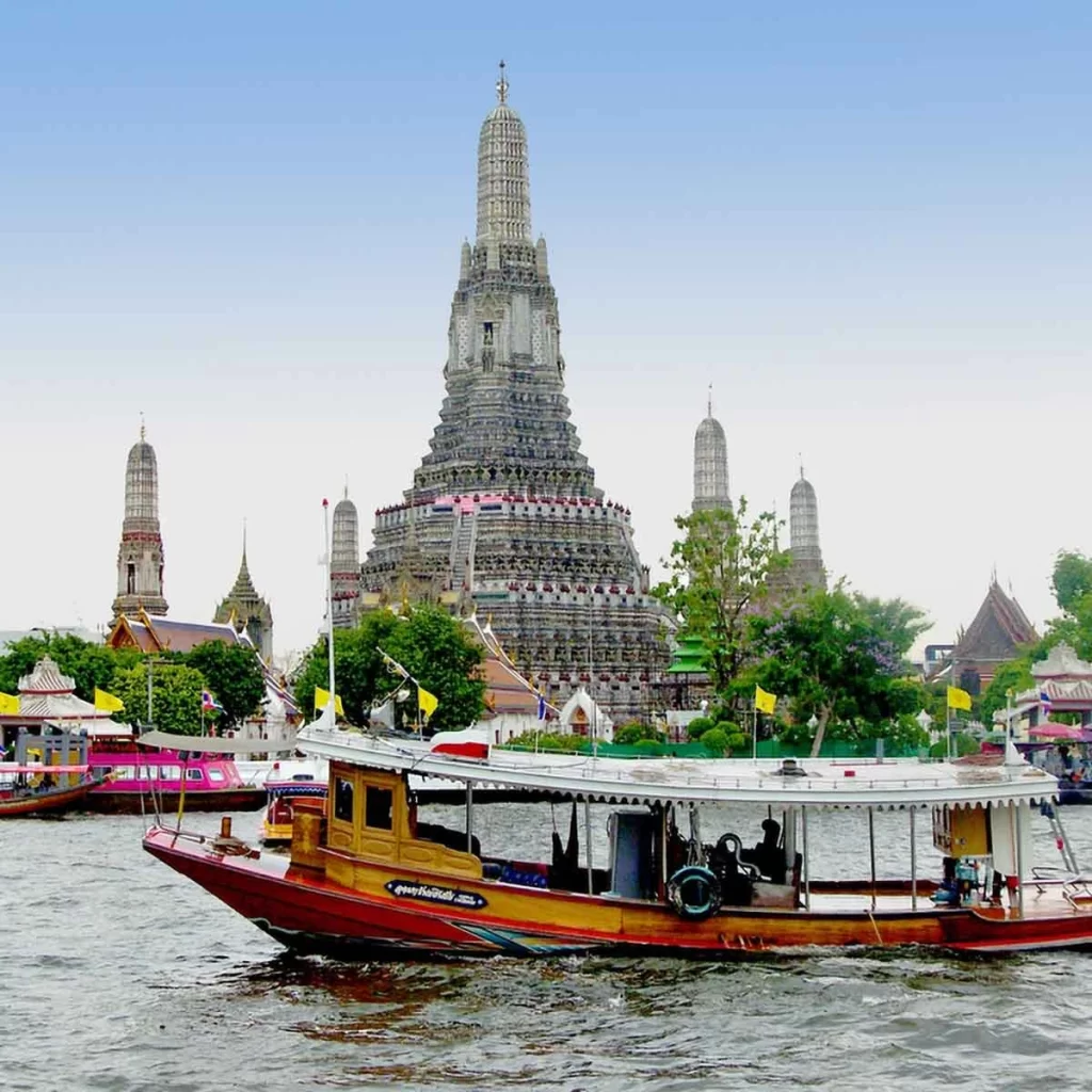 A luxurious hotel room with a panoramic view of the Chao Phraya River, highlighting Bangkok's premium hospitality options.