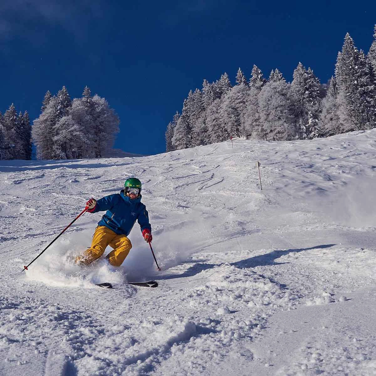 Picturesque Colorado ski town surrounded by snow-covered mountains, cozy cabins, and bright festive lights during winter