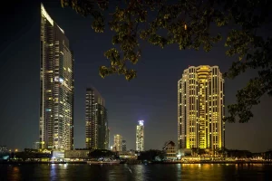 The Peninsula Bangkok, a luxurious riverside hotel featuring stunning Chao Phraya River views, a riverside pool, and world-class dining experiences.