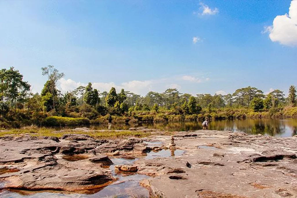 Clear water reflecting the sky and trees at Anodard Pond, Phu Kradueng