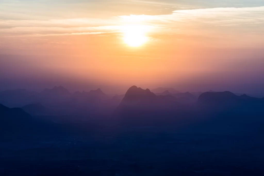 Sunrise at Pha Nok Aen, a stunning viewpoint at Phu Kradueng, with misty mountains and soft morning light