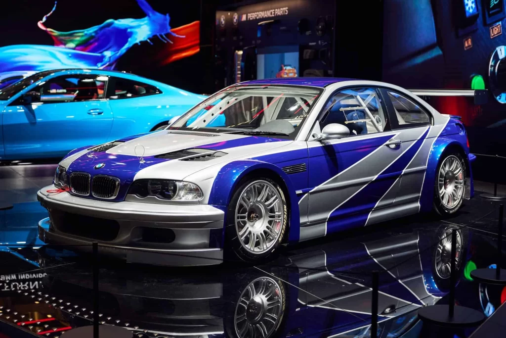 BMW M3 GTR showcased in BMW Welt, a silver-and-blue iconic car from Need for Speed: Most Wanted brought to reality