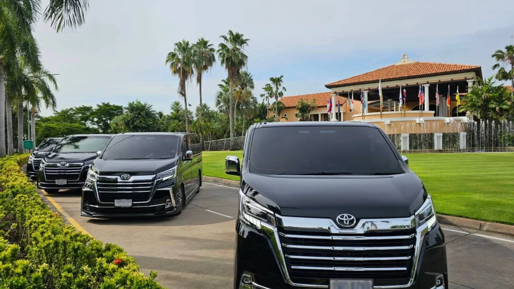 Luxury Toyota Majesty chauffeured van rental parked at an exclusive resort, offering premium transport for VIPs and executives in Thailand.