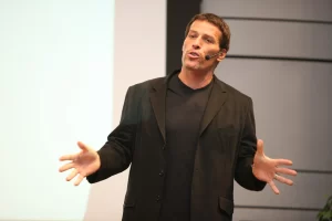 Tony Robbins, the renowned motivational speaker and author, delivering an inspirational speech on stage