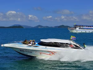 A speedboat carrying tourists across the blue waters towards Banana Beach, Phuket